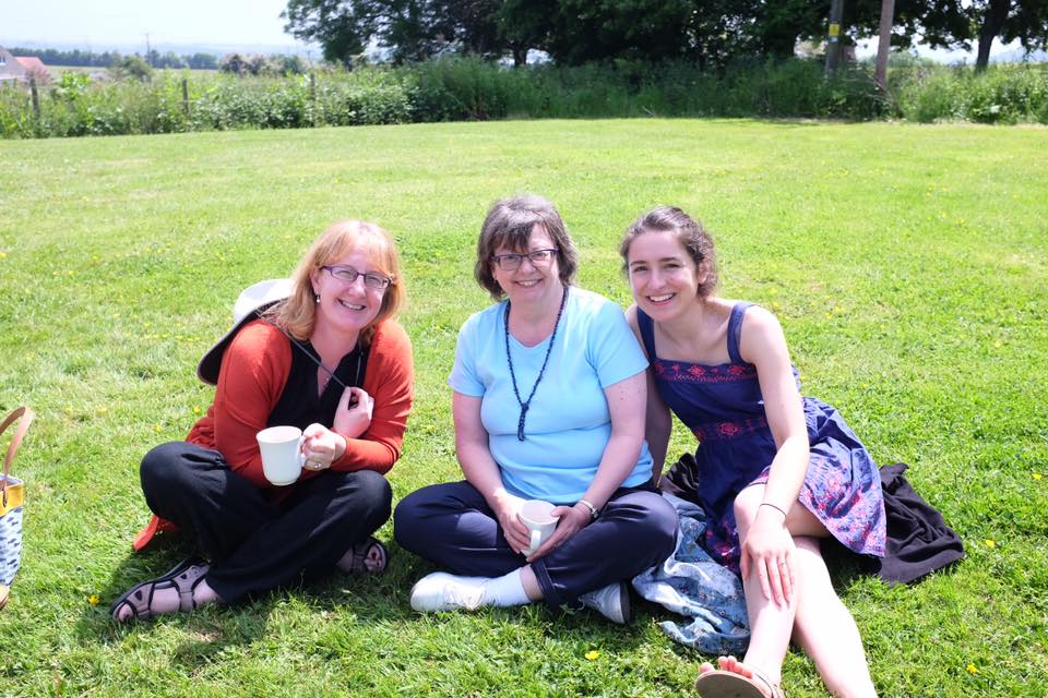 Three women seated on nice lawn